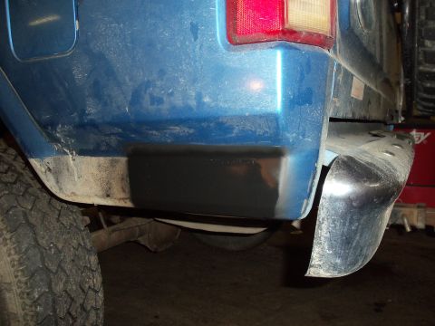 1985 Ford Bronco - Rear view of a 1985 Ford Bronco showing the bumper corner and tire.