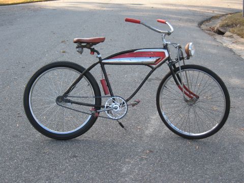 1994 Ford Bronco - A vintage bicycle with a red seat and handlebars sits on an asphalt road.