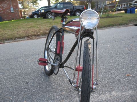1994 Ford Bronco - A vintage bicycle is parked on a street, with cars visible in the background.