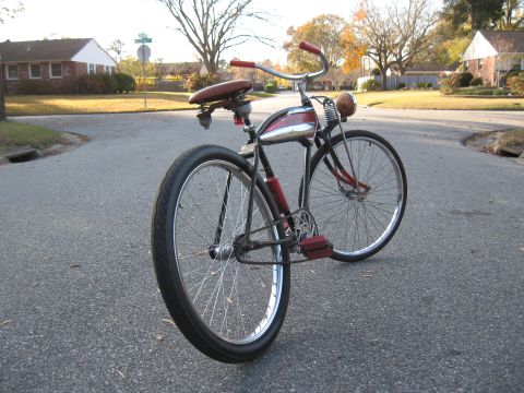 1994 Ford Bronco - A vintage bicycle with a distinctive chrome tank and red accents is parked on a suburban street.