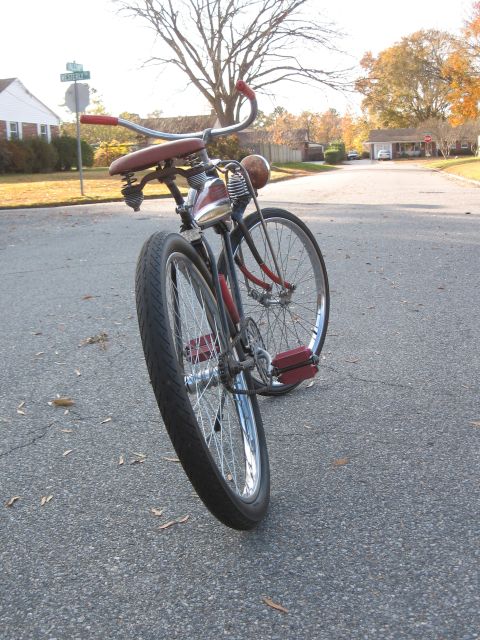 1994 Ford Bronco - A vintage bicycle with a spring-loaded seat and a headlight sits on a residential street.