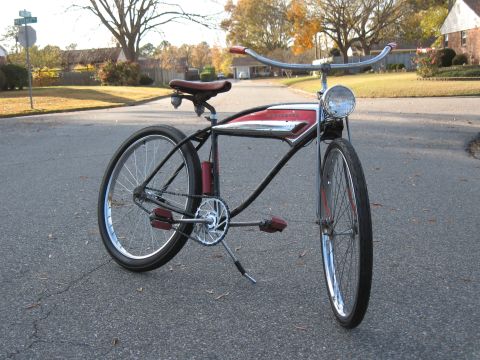 1994 Ford Bronco - A custom bicycle with a red frame insert and chrome handlebars sits on an asphalt road.