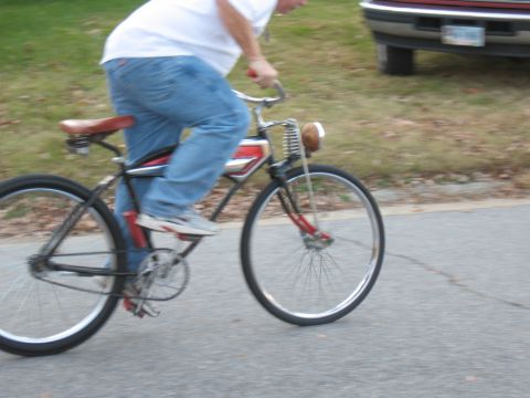 1994 Ford Bronco - A person rides a vintage bicycle with a headlight and distinctive red stripe detail on its frame.