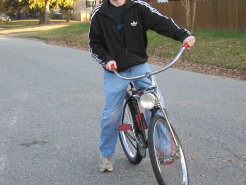 1994 Ford Bronco - A person rides a bicycle down a suburban street.