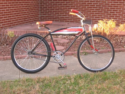 1994 Ford Bronco - A vintage cruiser bicycle with a distinctive red and chrome frame is parked on a sidewalk.