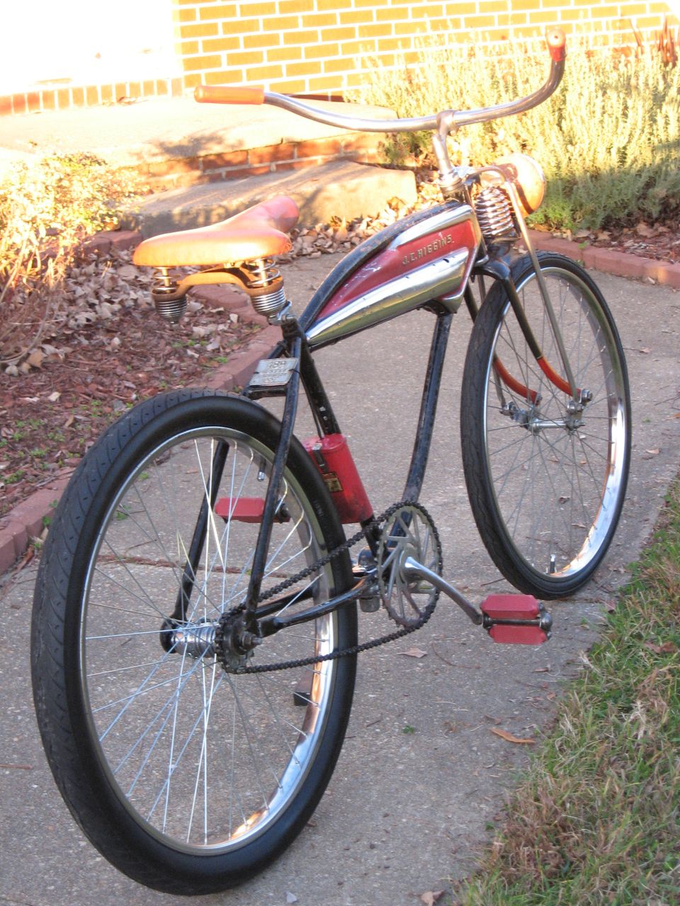 Old Schwinn bicycle with red pedals and a chrome tank