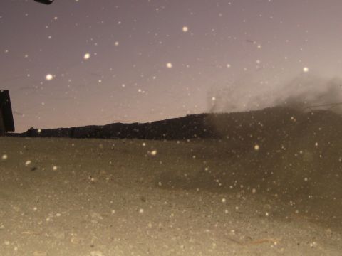 1996 Ford Bronco - A scene of dusty ground and particles in the air under a hazy sky.