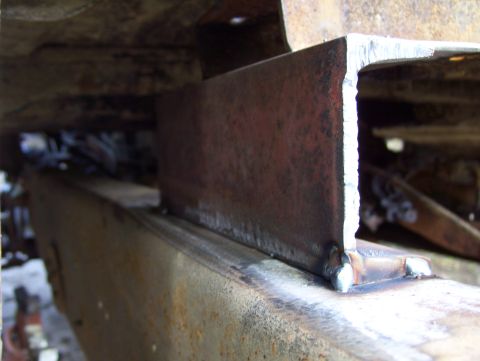 1972 Ford F-150 - Welded metal bracket on a rusty vehicle frame, with SuperMotors.net logo visible.
