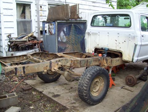 1972 Ford F-150 - The chassis of a 1972 Ford F-150 is visible, undergoing repairs in an outdoor setting.