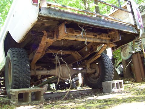 1972 Ford F-150 - The rear suspension and frame of a 1972 Ford F-150 pickup truck are visible, showing significant rust and wear.