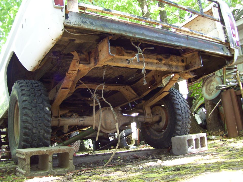 1972 Ford F-150 rear undercarriage, white, rusty, on cinder blocks