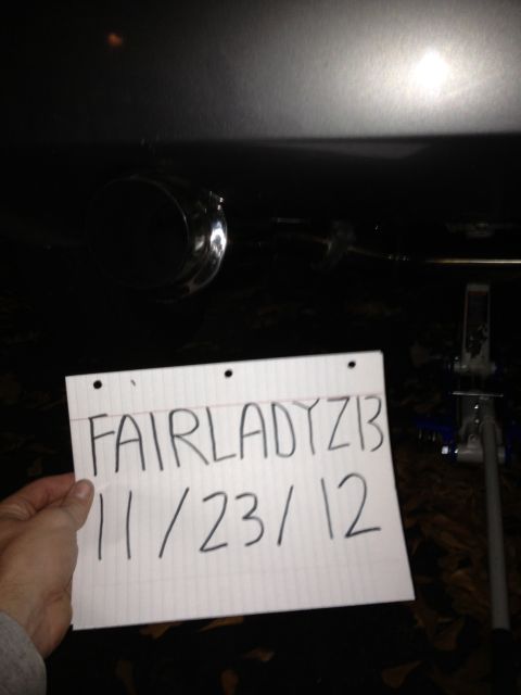 1996 Ford Bronco - A paper with 'FAIRLADYZ1B 11/23/12' is held up to an exhaust pipe.