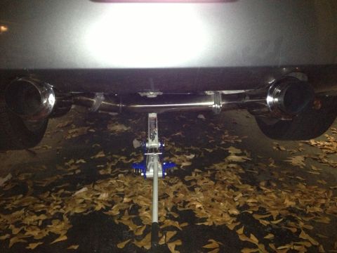 1996 Ford Bronco - A vehicle's dual exhaust system is shown while being supported by a floor jack.