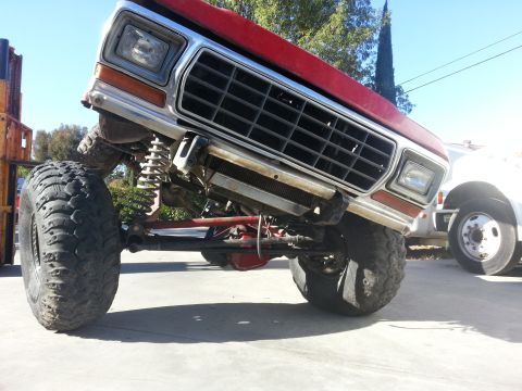 1978 Ford Bronco - This modified 1978 Ford Bronco features a prominent grille and aggressive off-road tires, its lifted suspension.