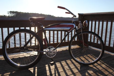 1994 Ford Bronco - A vintage bicycle with a distinctive red and chrome tank sits on a wooden pier at sunset.
