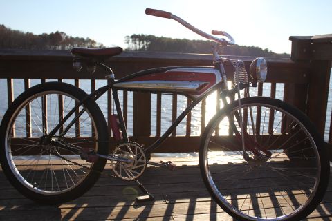 1994 Ford Bronco - A vintage bicycle with a distinctive tank design sits on a wooden pier, bathed in the warm glow of the sun.