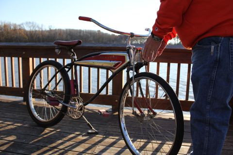 1994 Ford Bronco - A person stands next to a vintage bicycle on a wooden pier.