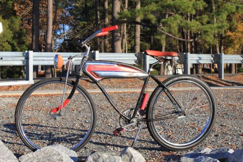 1994 Ford Bronco - A vintage bicycle with a distinctive red and chrome tank is parked outdoors.