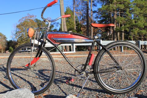 1994 Ford Bronco - A vintage J.C. Higgins bicycle with a distinctive chrome and red gas tank sits outdoors.