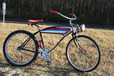 1994 Ford Bronco - A vintage bicycle with a distinctive chrome and red tank is parked outdoors on a grassy area.