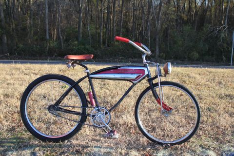 1994 Ford Bronco - A vintage bicycle with a distinctive chrome tank and red accents sits on a grassy roadside.