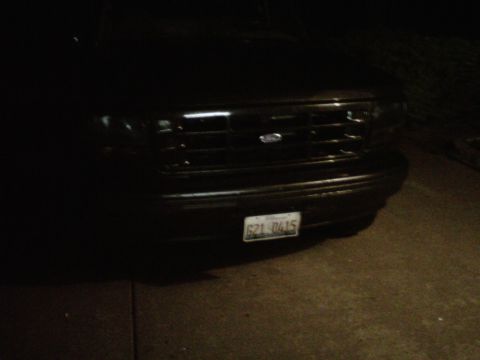 1994 Ford Bronco - The front of a black Ford Bronco is visible, showing its grille and license plate.