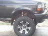 1994 Ford Bronco - Close-up view of the rear wheel well of a 1994 Ford Bronco, highlighting the tire and suspension.