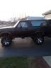 1994 Ford Bronco - Side view of a lifted 1994 Ford Bronco with custom wheels.
