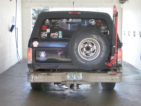 1996 Ford Bronco - This Ford Bronco is equipped with a spare tire, a high-lift jack, and numerous decals on its rear window.