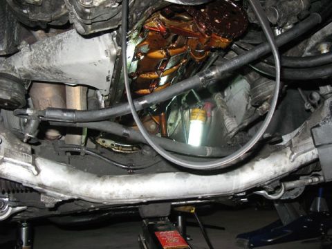1999 BMW 5 Series - The underside of a car's engine compartment, revealing the oil pan and transmission assembly.