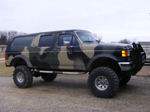1996 Ford Bronco - This 1996 Ford Bronco features a custom camouflage paint job and off-road modifications.