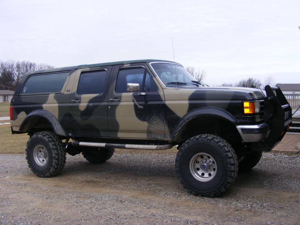 1996 Ford Bronco SUV with camouflage paint and aftermarket bull bar