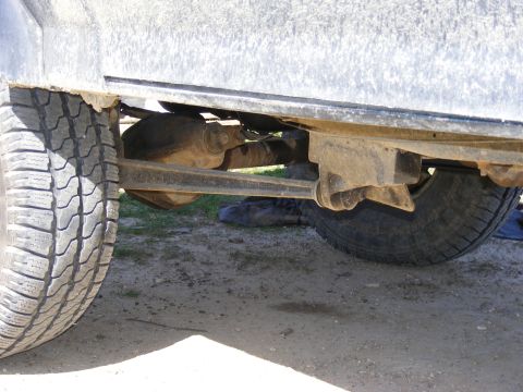 1996 Ford Bronco - Close-up view of the rear axle and suspension components of a vehicle.