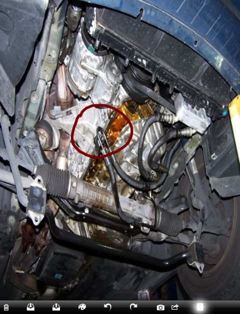 1999 BMW 5 Series - Underside view of car engine and steering rack showing an oil leak.
