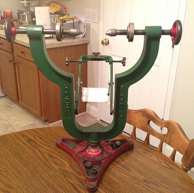 1994 Ford Bronco - This vintage tire changing tool, likely for a bicycle, features a green frame with red accents and adjustable screws for mounting.