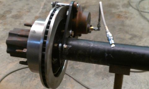 1995 Ford Bronco - Close-up of a vehicle's rear axle and disc brake system, showing the rotor and caliper.