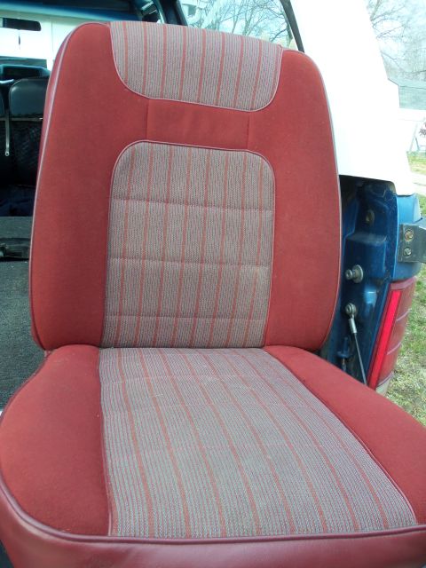 1985 Ford Bronco - Interior view of a 1985 Ford Bronco, its distinctive red and tan striped seat upholstery.