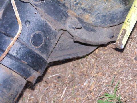 1990 Ford Bronco - A tape measure is used to measure a component of a vehicle part, showing a reading of 10.25 inches.