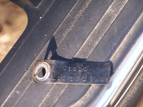 1990 Ford Bronco - Close-up of a part identification tag with stamped alphanumeric codes.