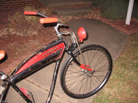 1994 Ford Bronco - A vintage J.C. Higgins bicycle with a distinctive frame design and bright orange handlebars is parked outdoors.