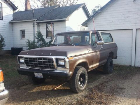 1979 Ford Bronco - This classic Ford Bronco is parked in a driveway with houses in the background.