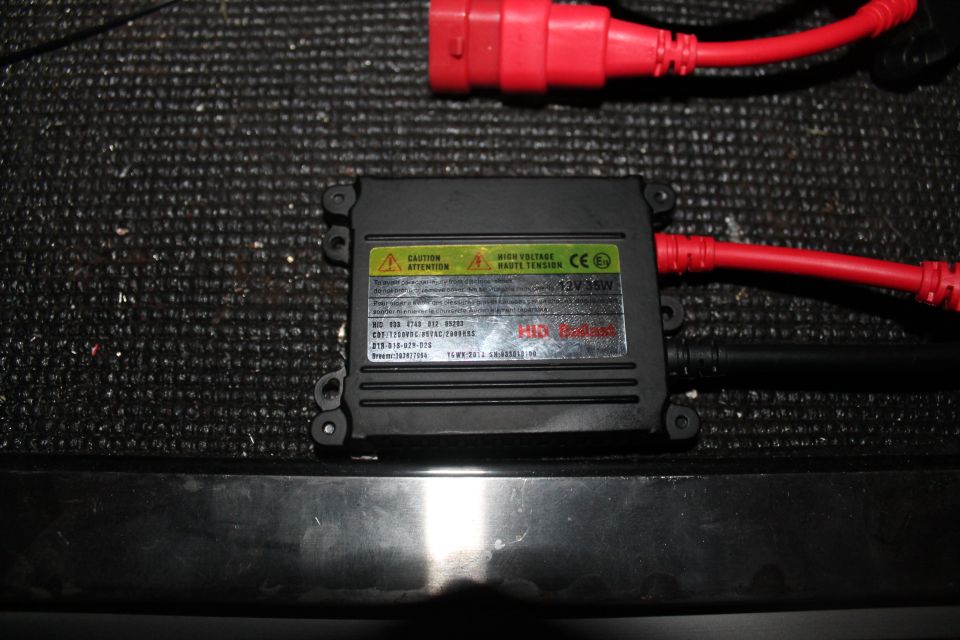 HID ballast with red power cables and a black wire