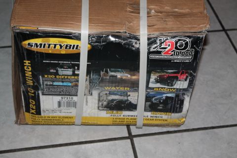 1990 Ford Bronco - Box for a Smittybilt X20 10,000 winch, showing the product and various off-road conditions.
