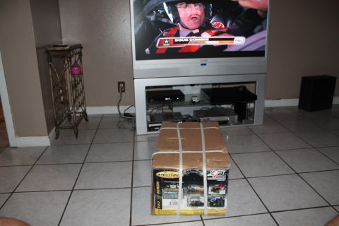 1990 Ford Bronco - Box for a Superwinch X90 winch sits on a tiled floor in front of a television.