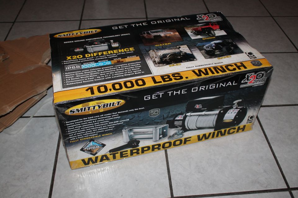 Box for a Smittybilt X20 10,000 lbs. waterproof winch. Shows winch and vehicle images