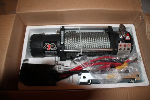 1990 Ford Bronco - New winch in its packaging, ready for installation on an off-road vehicle.