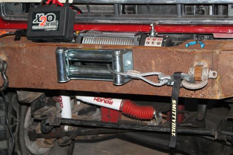 1990 Ford Bronco - A close-up view of a vehicle's front bumper assembly, showing off-road recovery equipment.