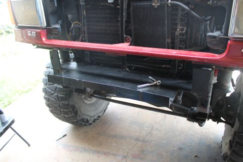 1990 Ford Bronco - Custom bumper fabrication in progress on a 1990 Ford Bronco, with a large off-road tire visible.