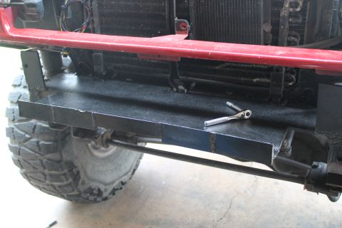 1990 Ford Bronco - A wrench rests on a newly fabricated bumper section, ready for installation on an off-road vehicle.