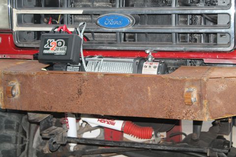 1990 Ford Bronco - This Ford truck features a custom, rusty front bumper with a winch and an X2O 10,000 control box mounted above it.